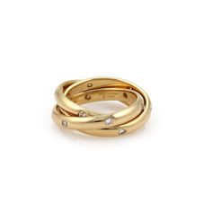 three gold rings with diamonds on the sides and one in the middle, set against a white background