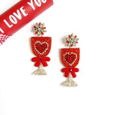 Embrace your love for love with these Sparkly Love Cup Earrings! The perfect celebration accessory for Valentine's Day, these red earrings add a touch of whimsy to any outfit. Show your love and have some fun with these charming earrings. ~ See all photos for length   ~ Post back   ~ Price is for 1 pair   ~ Soft felt backing IMPORTANT: Most Items are handmade so no two pieces are exact. Colors may vary and there can be imperfections. This is normal. Not for children. Adult use only. Celebration Champagne, Love Celebration, Champagne Earrings, Custom Gift Cards, Red Heart Earrings, Festival Earrings, Arrow Earrings, Beaded Earrings Patterns, Sparkly Earrings