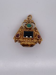 Vintage 18k yellow gold talisman charm with multi color gemstones. The charm is set with 2 Indicolite Tourmalines, 4 pink tourmalines and a large citrine on the bottom. The charm weighs 11.52 grams of gold. Collectible Gold Jewelry With Gemstone Accents, Unique Gold Gemstones For Jewelry Making, Antique Yellow Gold Jeweled Jewelry, 14k Gold Gemstones With Gemstone Accents, Antique Jeweled Yellow Gold Jewelry, Ceremonial Yellow Gold Jewelry With Charms, Traditional Yellow Gold Jewelry With Charms, Ceremonial Jeweled Yellow Gold Jewelry, Gold Pendant Gemstones For Jewelry Making