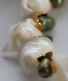 Trochid shells are mixed with Green Freshwater Pearls and golden accents with a bronze toggle-clasp , 7-inch. Visit our online store to find unique jewelry designs. Was $20.00 Elegant Green Jewelry For The Beach, Elegant Green Jewelry For Beach, Elegant Green Beach Jewelry, Elegant Handmade Shell Jewelry, Elegant Jewelry With Oyster Bracelet, Elegant Natural Stones Shell Jewelry, Elegant Jewelry With Natural Shell Stones, Elegant Jewelry With Natural Stones And Shell Shape, Elegant Shell Jewelry With Natural Stones