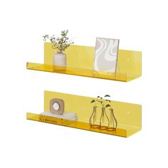 two yellow shelves with plants and pictures on them