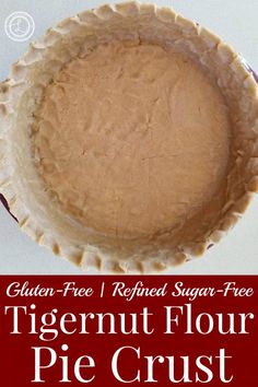 a close up of a pie crust on a white surface with the words gluten free refried sugar - free tigernut flour pie