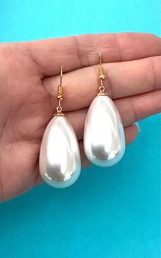 Large, faux pearl teardrop earrings from Olivia Divine. Shiney, white faux pearl, drop style earrings. Pierced, lightweight. Gold tone, hook style ear wire. Length 3.8 cm approx. Handmade design. Perfect for wedding, brides and bridesmaids. White Drop Teardrop Earrings For Party, White Teardrop Earrings For Party, White Teardrop Pearl Earrings For Party, White Pear-shaped Bridal Earrings For Party, Pear-shaped White Bridal Earrings For Party, Pearl White Teardrop Bridal Earrings For Party, Party Pearl Drop Teardrop Dangle Earrings, Party Teardrop Pearl Drop Dangle Earrings, Party Pearl Teardrop Earrings