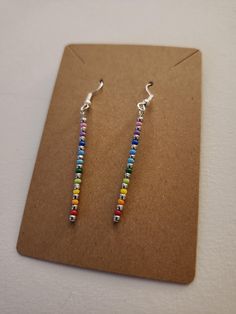 A pair of handmade rainbow drop earrings, ready to add a splash of color. Hypoallergenic Multicolor Sterling Silver Earrings, Rainbow Drop Earrings As A Gift, Rainbow Nickel-free Drop Earrings, Nickel-free Rainbow Drop Earrings, Nickel-free Rainbow Earrings Gift, Nickel-free Rainbow Earrings For Gift, Rainbow Nickel-free Earrings For Gifts, Adjustable Rainbow Earrings As Gift, Colorful Hypoallergenic Dangle Jewelry