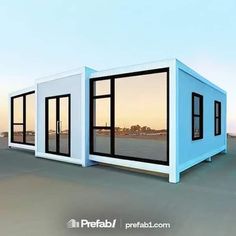 two blue and white shipping containers sitting on top of a beach