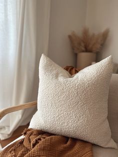 a white pillow sitting on top of a couch