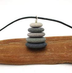 This adjustable long-length stone cairn pendant necklace features five pebbles worn smooth by the timeless action of Lake Michigan's sand and waves. A cairn pendant can symbolize a person's perseverance, one's path through life, a memory of a loved one, or a special place. The meanings are as individual as they are multiple. Special places, journeys, and the ones you love resonate close to the heart, so let this Lake Michigan offering represent one of these precious meanings. Thousands of years Pebble Stack, Stone Cairns, Lake Michigan Beaches, Rock Ideas, Beautiful Rocks