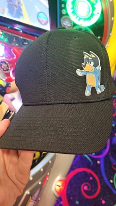 Bluey Themed with Bandit and Unicorse Hat.  (Custom Characters/designs welcomed.) Black Hat  Customization is available. Design on Flexfit Adult Unisex Cool & Dry Sport Cap (2 Sizes Available) Features 100% polyester Matching underbill Moisture-wicking High absorbency Supple fabric Quick-drying 3½" crown 6-panel, structured, mid-profile Fun Black Cotton Baseball Cap, Fun Black Adjustable Snapback Hat, Casual Black Costume Hat One Size, Fun Black Trucker Hat With Curved Brim, Black Fun Snapback Hat With Curved Brim, Fun Black Snapback Hat, Casual Black Costume Hat With Curved Brim, Fitted Black Cotton Hats, Cute Adjustable Black Baseball Cap