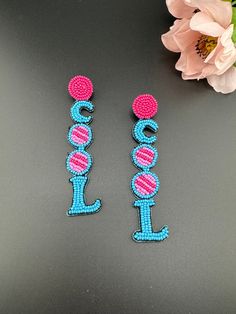 This is a beautiful Quirky beaded Earrings in Blue and Pink Cool(worded earrings) design. Very light weight to wear and looks good on any attire. This is very beautiful to look at and a perfect one for regular wear and also parties.  Color : Blue, Pink length : 4 inch width : 0.75 inch Each earring Weight : 3.7 grams Material : Beads, Fabric Beautiful High Quality, premium jewelry. Free US standard shipping. Hand crafted in India with the finest design, this earring is of premium quality and uni Trendy Dangling Beads Earrings For Beach, Trendy Adjustable Beaded Earrings With Dangling Beads, Trendy Dangle Beaded Earrings For Festivals, Trendy Beaded Dangle Earrings For Festival, Trendy Festival Dangle Beaded Earrings, Trendy Beach Earrings With Dangling Beads, Trendy Single Beaded Earring For Party, Trendy Beaded Dangle Earrings With Ear Wire, Trendy Beaded Earrings With Dangling Beads For Summer