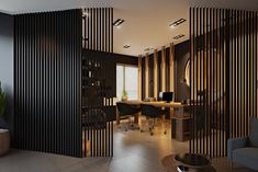 an office with wooden partitions in the middle and black furniture on the other side