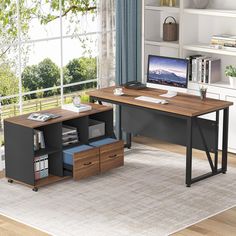 an office desk with two drawers and a computer monitor on top of it in front of a window