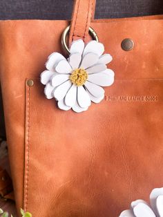 New Custom Made Daisy Leather Flower Charm in White! Gorgeous leather with beautiful dimension. New Large Daisy Leather Flower Charm for totes, purses and bags. Buy a few colors and layer!  Handmade from genuine leather and each petal formed by hand.  Large Size--Approximately 4in x 3.5in  *Genuine Leather Includes a brass open clasp ring to attach to handles or d-rings. Each piece is completely handmade and will have some variations from flower to flower. Leather Flower Earrings, Leather Bag Charm, Leather Purse Charms, Leather Charms, Large Daisy, White Daisy Flower, Handmade Leather Jewelry, Diy Leather Projects, Flower Purses