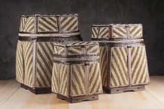 three brown and white baskets sitting on top of a wooden floor