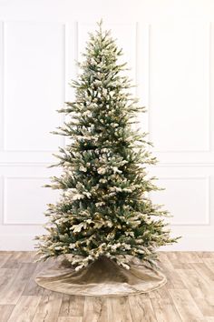 a white christmas tree with snow on it