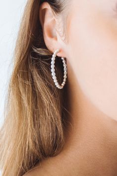 A classic hoop earring with small pearls all around. Small Hoop Jewelry For Everyday Elegance, Classic Everyday Pearl Drop Jewelry, Everyday Pearl White Earrings, Classic Round Pearl Chain Earrings, Classic Pearl Chain Earrings, Classic Jewelry With Pearl Charm, Classic Single Pearl White Earring, Pearl White Round Earrings For Everyday, Chic Pearl-embellished Pearl White Jewelry