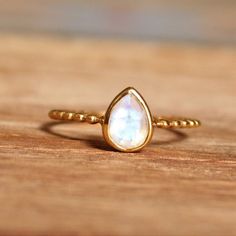 Rainbow moonstone ring, Gold plated Sterling silver, 0.5 micron nickel free plating, stackable ring, minimalist ring, midi ring, statement ring, cocktail ringDescription:I make the gemstones myself for my valued customers so I assure you that the gemstones are NATURAL and are made from ETHICALLY SOURCED ROUGHSThe rest of the ring is made from 925 STERLING SILVER i.e 92.5% pure silver. And it DOESN'T HAVE ANY LEAD OR NICKEL.0.5 MICRONE GOLD PLATING has been done. With time, it will wither like an Minimalist Teardrop Stackable Jewelry, Adjustable Dainty Moonstone Jewelry, Dainty Teardrop Adjustable Rings, Minimalist Adjustable Moonstone Ring As Gift, Minimalist Adjustable Moonstone Ring For Gift, Adjustable Minimalist Moonstone Ring As Gift, White Stackable Moonstone Rings With Ethical Gemstones, Handmade Minimalist Moonstone Promise Ring, Elegant Handmade Moonstone Stackable Rings