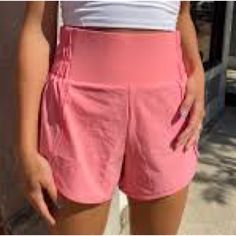 These Highwaisted Running Shorts Are Functional But Still Fashionable, Featuring Scalloped Detail On The Side, Inner Lining, And A Partially Ruched Waistband Detail. Perfect For Heading To The Gym, Running Errands, Or A Casual Day Out. Super Cute And Comfy!, Nwt Pink/Coral Fits True To Size Inner Lining Partially Ruched Waistband Size Small Inseam: 3.75" Self: 88% Nylon, 10% Spandex Inner Lining: 80% Polyester, 20% Spandex Machine Wash Cold | Tumble Dry Low Sporty High-waisted Activewear Shorts With Built-in Shorts, Summer Training Bottoms With Built-in Shorts, Sporty Bottoms With Built-in Shorts And Athletic Fit, High Waist Sports Shorts With Contoured Waistband, Sporty Running Bottoms With Built-in Shorts, Spring Gym Bottoms With Built-in Shorts, Sporty High-waisted Shorts With Contoured Waistband, Athletic Bottoms With Built-in Shorts For Sports, High-waisted Yoga Shorts Sportswear