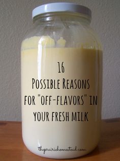 a glass jar filled with milk sitting on top of a wooden table