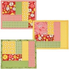 three patchwork placemats with flowers on them