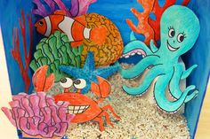 an ocean scene made out of cardboard with sea animals and fish on the bottom half