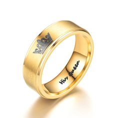 an 18k yellow gold wedding ring with the word love written on it and a crown