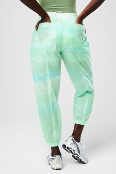 Sheer Ripstop Parachute Pant Fabletics green female Activewear >> Womens >> Bottoms >> Pants & Joggers >> Lounge Pants plus Everyday External Pockets Green Nylon Parachute Pants Athleisure, Green Nylon Parachute Pants For Athleisure, Green Tapered Leg Joggers With Elastic Waistband, Green Tapered Leg Sweatpants With Elastic Waistband, Green Nylon Parachute Pants With Relaxed Fit, Green Nylon Sporty Parachute Pants, Green Nylon Bottoms With Elastic Waistband, Stretch Green Joggers With Elastic Waistband, Green Parachute Pants With Elastic Waistband For Sports