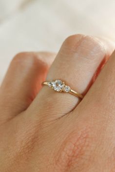 a woman's hand with a diamond ring on it