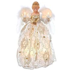 an angel figurine with white wings and gold trimmings, holding two lit candles