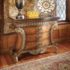 a table with a lamp on top of it next to a clock and other items