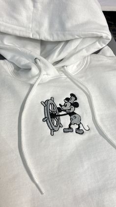 One (1) Steamboat Willie Hoodie or Sweatshirt Sweatshirt: Hanes 50/50 cotton/poly Hoodie: Jerzees 50/50 cotton/poly NuBlend® pill-resistant fleece Follow our care instructions: Wash in cold water with similar colors, avoid bleach, tumble dry on low, and iron on low heat if necessary. Do not dry clean. White Cotton Hoodie With Embroidered Logo, White Fleece Crew Hoodie, White Crew Hoodie With Embroidered Graphics, Casual Hoodie With Machine Embroidery For Streetwear, White Hoodie With Embroidered Graphics, Casual Embroidered Hoodie For Streetwear, White Embroidered Crew Hoodie, White Embroidered Crew Neck Hoodie, White Hoodie With Custom Embroidery For Winter