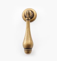 an antique brass door handle on a white background