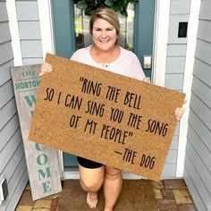 a woman holding a sign that says ring the bell so i can sing you the song of my people