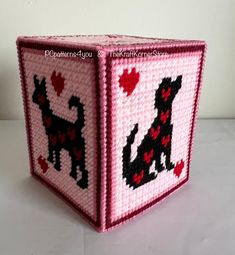 a pink box with black dogs on it and hearts in the shape of heart shapes