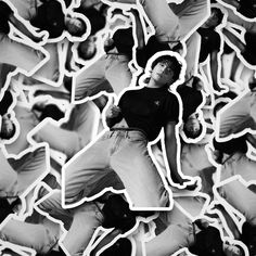 a black and white photo of a man jumping in the air with his hands up