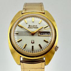 Vintage Bulova Accutron 10k RGP Gold Men's Day/Date 36mm Watch  This is truly a classic watch that would be a great addition for any collection.  Gold electroplated case and rolled gold back plate. New old stock, gold plated Scott Brand expansion bracelet is in excellent condition  Freshly installed battery and tuning fork movement is keeping perfect time. Ships immediately Vintage Gold Watch With Day-date Display, Retro Gold Watch With Date Display, Vintage Watch With Day-date Display For Formal Occasions, Vintage Formal Watch With Day-date Display, Retro Analog Watch For Anniversary, Vintage Watches With Day-date Display, Vintage Gold Watch With Date Display, Vintage Gold Watches With Date Display, Vintage Anniversary Watch With Date Display