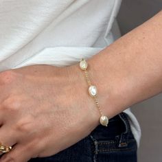 Indulge in the timeless beauty and sophistication of our 18k Gold Filled Spaced Baroque Pearl Bracelet. The perfect blend of elegance and delicacy, this classic piece exudes a luxurious charm that will elevate any outfit. Add a touch of opulence to your wardrobe and captivate with every turn of your wrist. Metal: 18k Gold Filled Width: 10mm Simulated Baroque Pearl Beads Size: 6.5 + 1 inch adjustment. Hypoallergenic Water-resistant Handcrafted in Brazil Elegant Pearl Chain Jewelry, Elegant Gold Plated Bracelet For Gift, Elegant Yellow Gold Bracelet With Elegant Design, Elegant Adjustable Bracelets For Anniversary, Elegant Gold Bangle Bracelet With Elegant Design, Luxury White Gold Bracelets With Pearl Chain, Elegant Adjustable Pearl Chain Bracelet, Yellow Gold Elegant Bracelets, Luxury White Gold Pearl Chain Bracelets