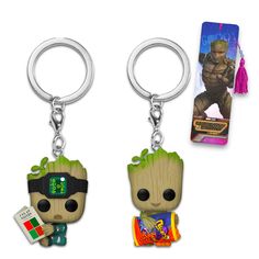 two key chains with the same character on each one and an action figure in front of them