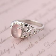 Presenting you A Beautiful Rose Quartz Ring In Filigree  Style Shank Ring with Oval Cabochon Rose Quartz . The color of the cabochon used is really soothing to the eyes. Perfect Gift For Her or as a proposal Ring or you can gift yourself Item No: skj.18.501 Item: Pink Quartz Ring in 925 Sterling Silver Primary Stone: Pink Quartz Secondary Stone:-- Article Weight: 5.1 gms primary stone Size: 9x7  mm Ring Length: 2.1 cm Ring Width: 1.1 cm Maintenance Tips 1. Keep the jewelry away from direct heat, water, perfumes, deodorants, and other strong chemicals.  2. Wipe the Jewellery gently with a chamois cloth or leather swatch after every use.  3. Wiping the jewelry with a soft cloth after removing the jewelry would a PAYMENT POLICY  PAYMENT THROUGH PAYPAL ONLY. SHIPPING POLICY Processing time for Sterling Silver Oval Rings For Valentine's Day, Silver Oval Rings For Valentine's Day, Pink Oval Moonstone Ring In Sterling Silver, Pink Oval Cabochon Jewelry For Wedding, Pink Oval Cabochon Wedding Jewelry, Rose Gold Oval Moonstone Ring, Oval Rose Gold Moonstone Ring, Elegant Pink Oval Cabochon Ring, Elegant Oval Rose Quartz Rings