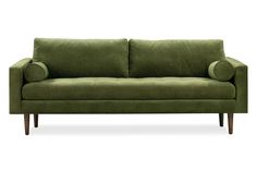 a green couch sitting on top of a white floor