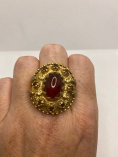 Vintage red carnelian golden bronze ring Lovely vintage golden bronze setting Size 8 My jeweler would re size for $20 fee All rings are shipped in a nice gift box. Check out our over a THOUSAND great reviews Engraving is $4 per letter and is not always perfect depending on the piece. It can take a few days if the jeweler is busy. This is payable to Paypal Judithsltd@gmail.com Ornate Gold Ruby Ring, Ornate Gold Ring With Ruby, Ornate Gold Rings With Ruby, Ornate Yellow Gold Ruby Ring Gift, Red Antique Collectible Jewelry, Unique Gold Ruby Ring For Gift, Victorian Cabochon Rings As Gifts, Vintage Red Cabochon Ruby Ring, Victorian Cabochon Rings For Gift