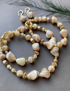 Zonerse feminine beautiful jewelry set of Natural Trochus Shell beads. This set can be worn in many ways such as festive and special occasions. This necklace can also be combined with casual outfits, for a touch of extra charm. Bracelet and earrings match very well with the necklace. ☀️Stone: Natural Trochus Shell Irregular Beads 7 -16mm and 8mm ☀️The length is approximately 52 cm (incl. clasp) ☀️Details and closure are gold plated ☀️Bracelet is 17 cm I accept custom orders for jewelry: earrings Pearl Jewelry Set, Mother Of Pearl Jewelry, Necklace Stone, Pearl Jewelry Sets, Eco Printing, Felted Scarves, Set Necklace, Gold Plated Bracelets, Shell Beads