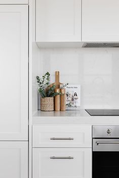 a kitchen with white cabinets and an oven