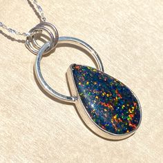 Kyocera Opal handcrafted into a cabochon and placed in a customized sterling silver bezel setting. Includes an 18 inch, solid sterling silver 1.2mm serpentine chain. Pendant measures 0.8" x 1.5" and the cabochon is approximately 16 x 24mm. Sterling Silver Jewelry With Polished Snake Chain, Sterling Silver Snake Chain Jewelry With Polished Finish, Sterling Silver Large Round Pendant Jewelry, Handmade Sterling Silver Snake Chain Jewelry, Sterling Silver Snake Chain Jewelry In Silver, Sterling Silver Snake Chain Necklace For Gifting, Sterling Silver Necklace With Large Pendant And Snake Chain, Silver Sterling Silver Jewelry With Snake Chain, Handmade Silver Snake Chain Jewelry