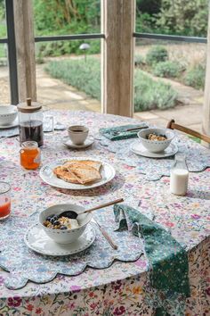 the table is set with breakfast food and drinks