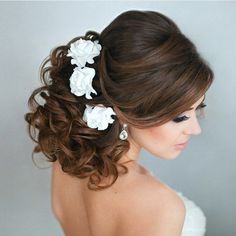 a woman in a wedding dress with flowers in her hair and the back of her head