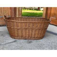 a large wicker basket sitting on the ground