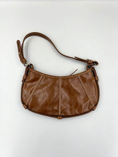 This adorable little brown man made leather bag is by Express. Perfect size if you just want the necessities. It measures approximately 5.5 (with strap 14.5) x 10.5 inches. Circa 1990s, it's a fun bag for anyone who loves vintage bags. In great vintage condition! Please keep in mind that I offer vintage and pre-owned items that may show normal signs of use including fading, small stains, scratches, chips or dings. See all photos and descriptions before purchasing. Vintage Faux Leather Satchel Shoulder Bag, Vintage Brown Faux Leather Shoulder Bag, Vintage Brown Faux Leather Satchel, Retro Faux Leather Shoulder Bag For Everyday, School Brown Hobo Bag, Vintage Faux Leather Shoulder Bag, Vintage Faux Leather Shoulder Bag For Everyday, Retro Brown Faux Leather Shoulder Bag, Brown Hobo Bag For School