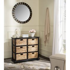 a white dresser with baskets and a round mirror