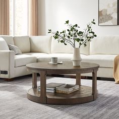 a living room with white couches and a coffee table in front of a window