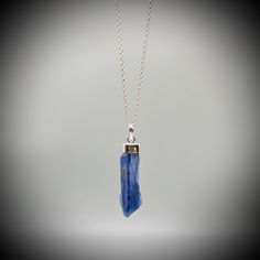 Blue Kyanite Crystal Point  and Sterling Silver Pendant on your choice of with a  16 or 18 inch sterling silver belcher chain. This is a beautiful Kyanite crystal blade, approximately 3.5cm x 1cm Our jewellery always comes beautifully gift boxed and bagged with a crystal meaning card.  BLUE KYANITE BENEFITS Aids with healing of the throat Strengthens the voice and gives confidence Creates Soothing and harmonic energy Encourages self-expression and communication All of our crystal are ethically sourced and are treated with love, care and respect. Blue Kyanite Gemstone Necklace, Blue Kyanite Necklace For Gift, Blue Sodalite Pendant Necklace, Blue Gemstone Crystal Necklace As A Gift, Blue Nickel-free Crystal Necklace As Gift, Blue Birthstone Jewelry For Healing, Blue Sterling Silver Necklace For Gift, Sodalite Pendant Necklace For Gift, Sapphire Kyanite Gemstone Necklace